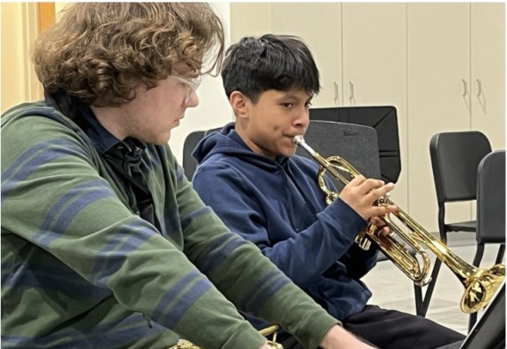 Band teacher and student playing instrument